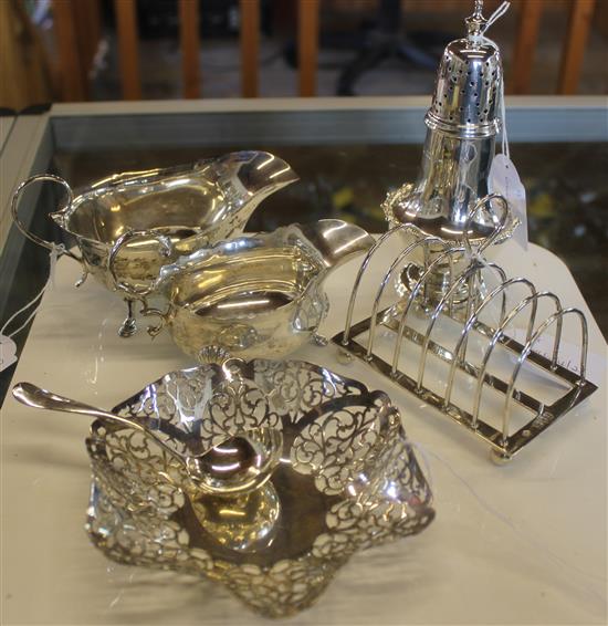 Silver toast rack, 2 sauce boats, pierced bowl, ladle and sugar caster